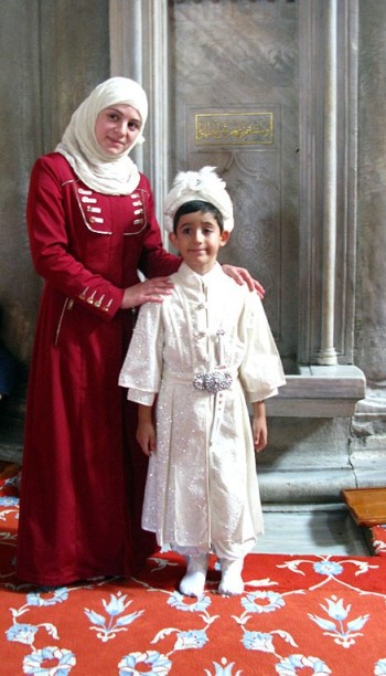 Mother and child in tradituonal costume in the Blue Mosque Istanbul
